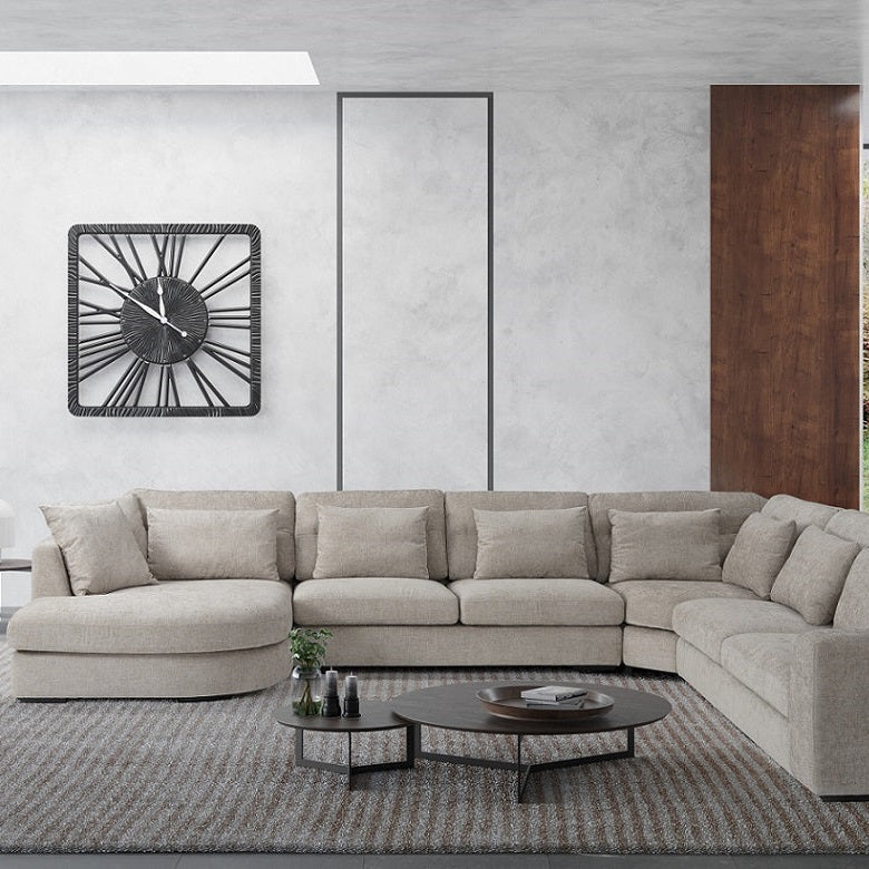 Modern living room with a beige sectional sofa, coffee table, and decorative items.